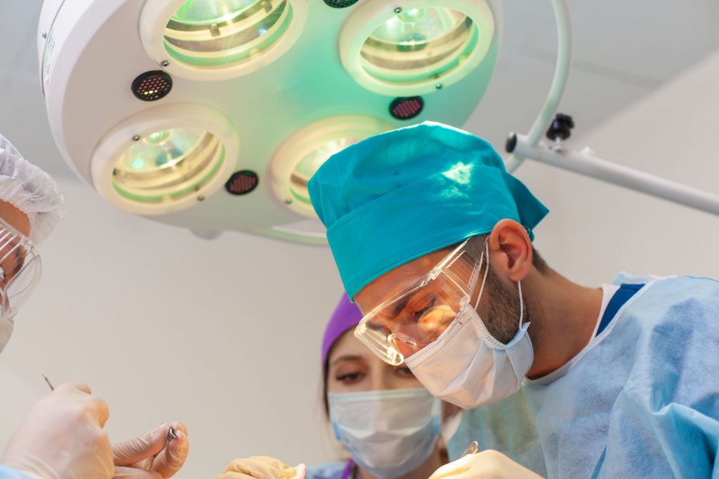 Baldness treatment. Hair transplant. Surgeons in the operating room carry out hair transplant surgery. Surgical technique that moves hair follicles from a part of the head